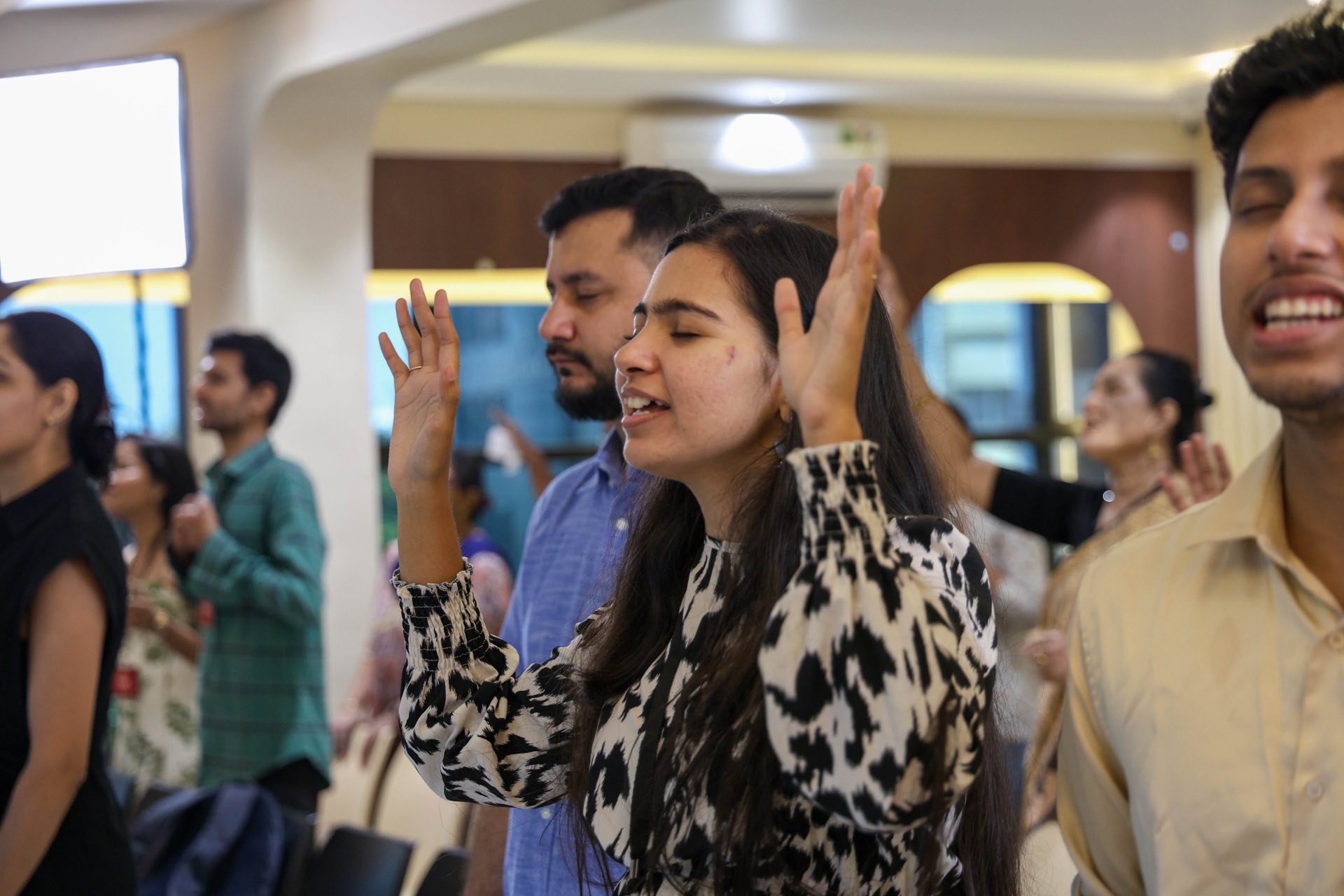 Congregation raising hands in worship