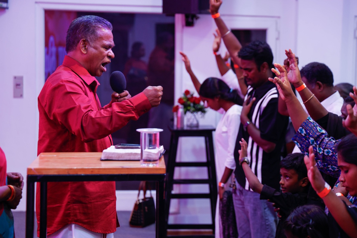 Freedom Tamil pastor preaching as the congregation worships