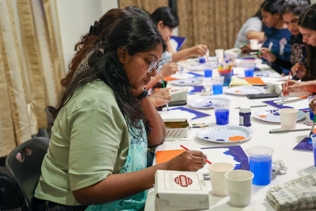 Women painting together at a SHE ministry creative gathering